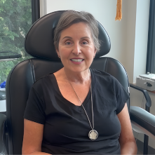 Smiling woman in GentleCure treatment chair chair