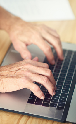 Hands typing on a keyboard